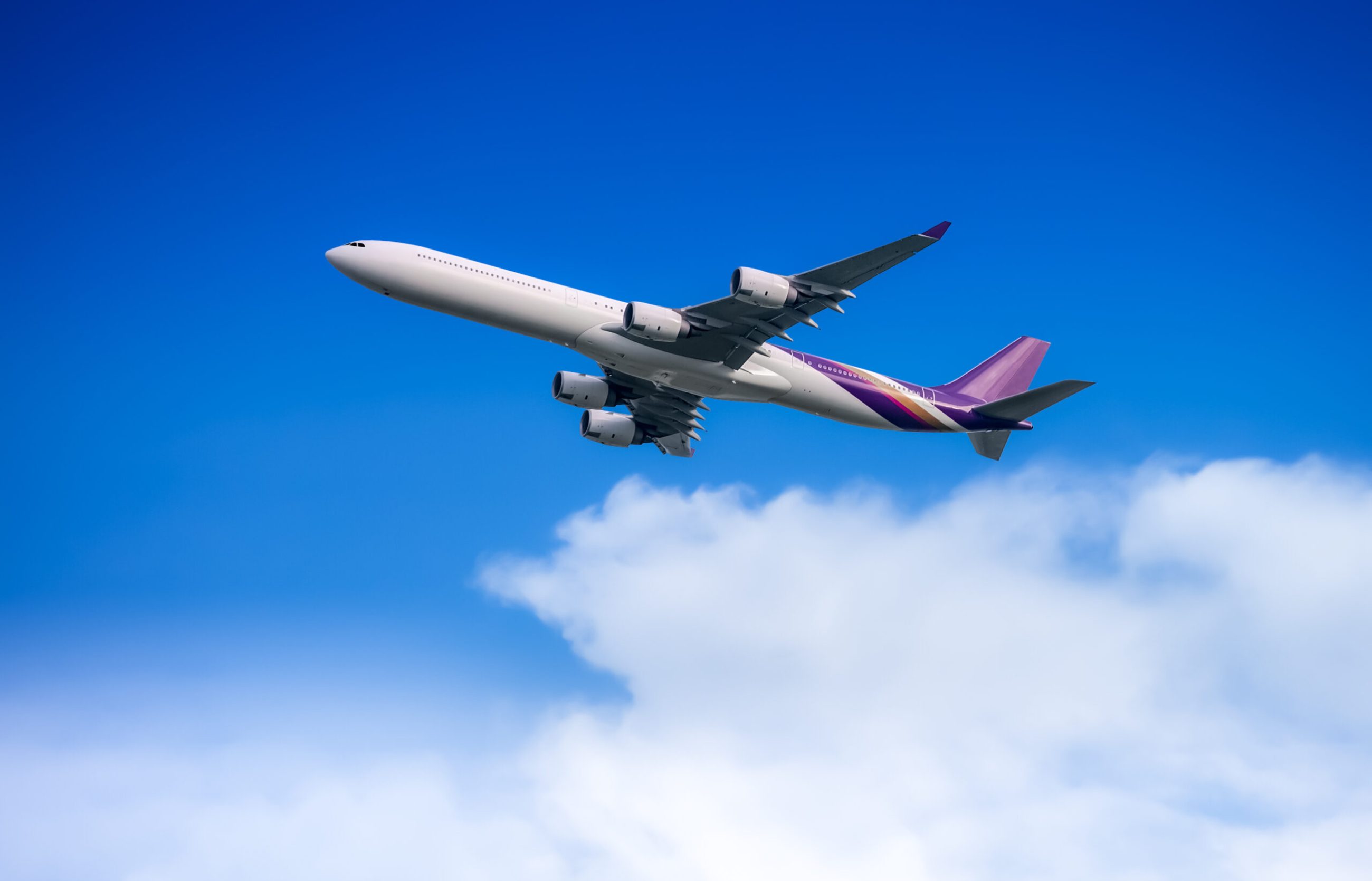 Large passenger airplane flying in the sky in concept of travelling abroad
